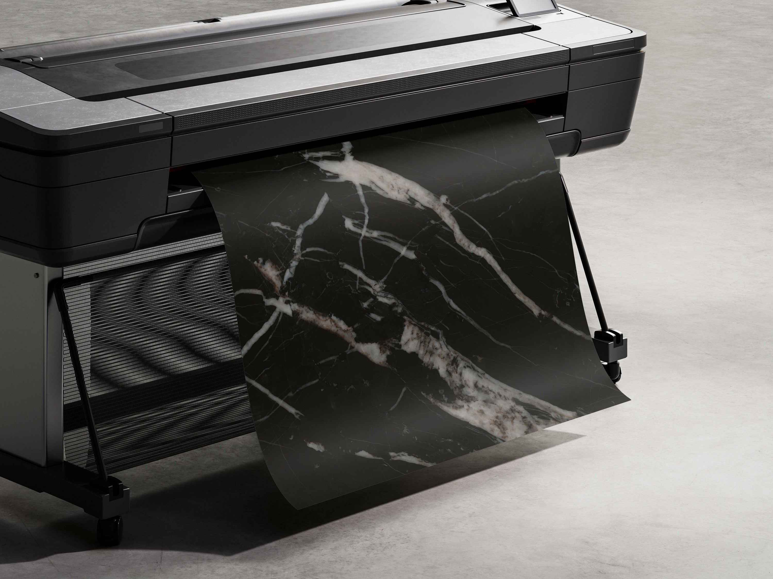 A large format printer dispensing a sheet of black marble texture.